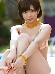 Lovely and cute Japanese av idol Mana Sakura strips her swimming suit on the pool side